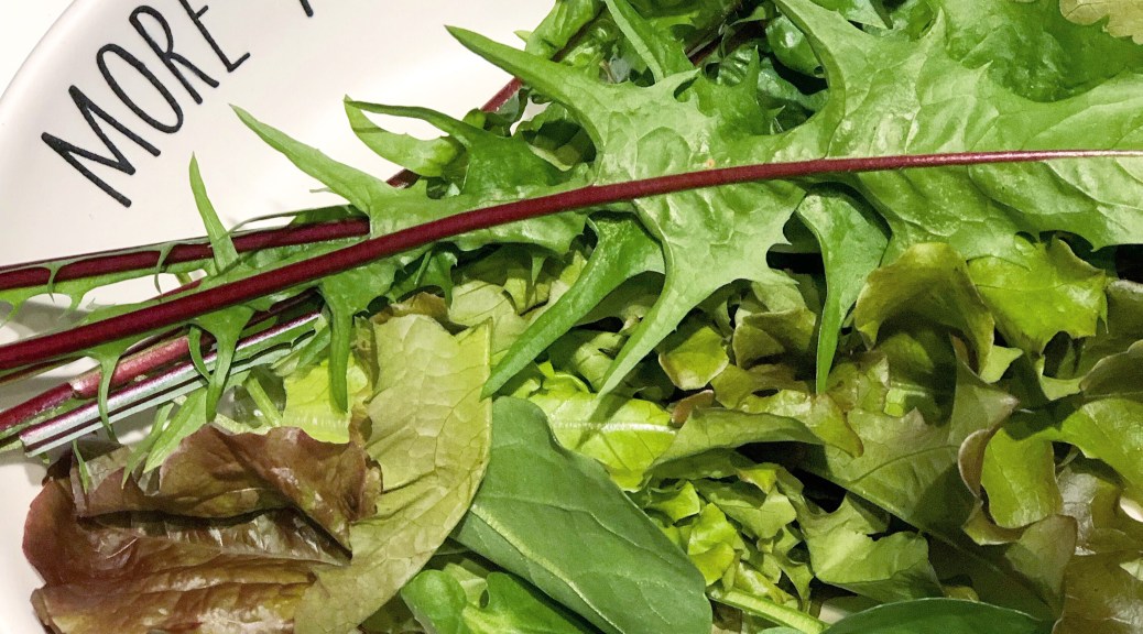 Plate of greens with dandelion